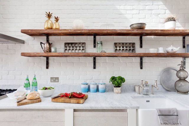 Dark open shelves in white kitchen interior design