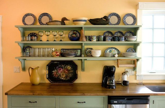 Open shelves of painted wood in the kitchen