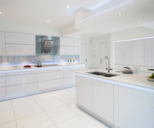 White floor tiles and white ceiling with spotlights in the kitchen