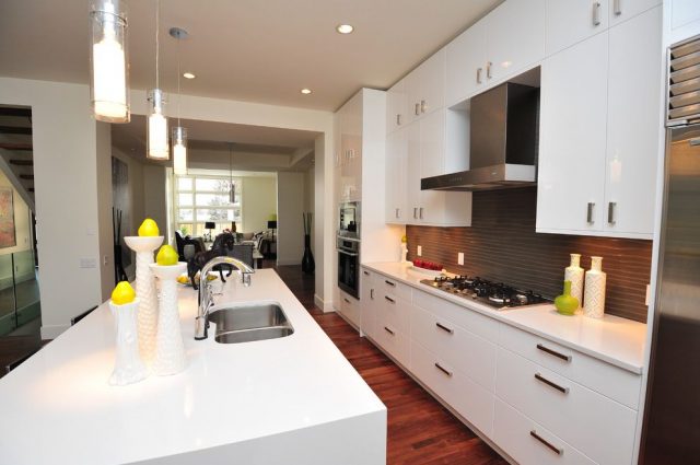 White kitchen with dark wooden floors