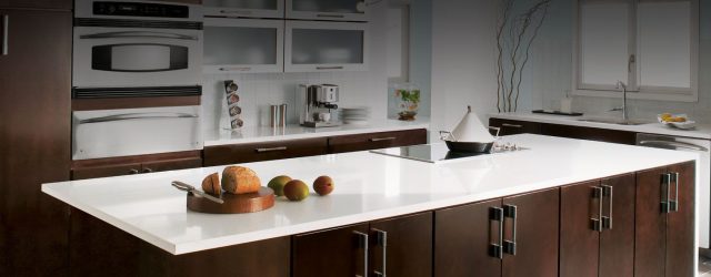 Kitchen island with white countertop and dark cabinets