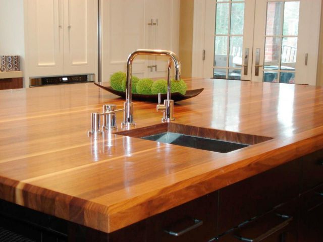 Kitchen island with wooden countertops and dark cabinets