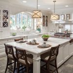 White kitchen island with seating and cabinets